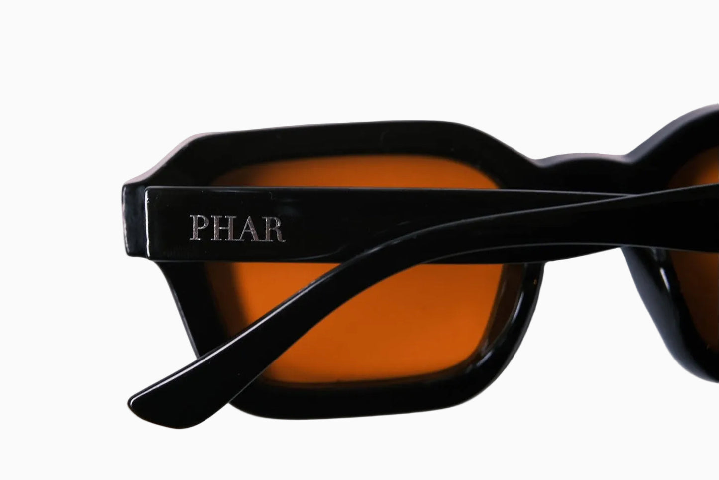 Sunglasses with 'PHAR' branding on a light pink background