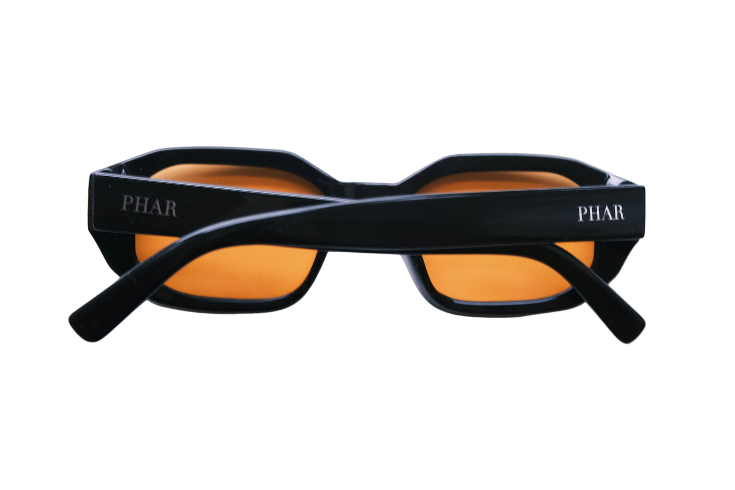 Black sunglasses with orange lenses on a white background
