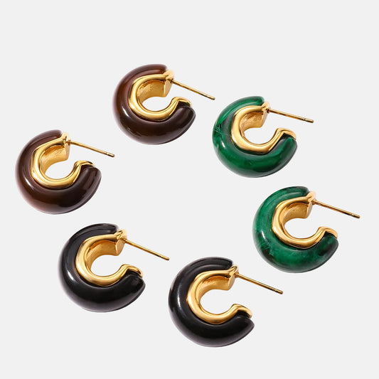 Set of hoop earrings in gold, brown, green, and black on a white background