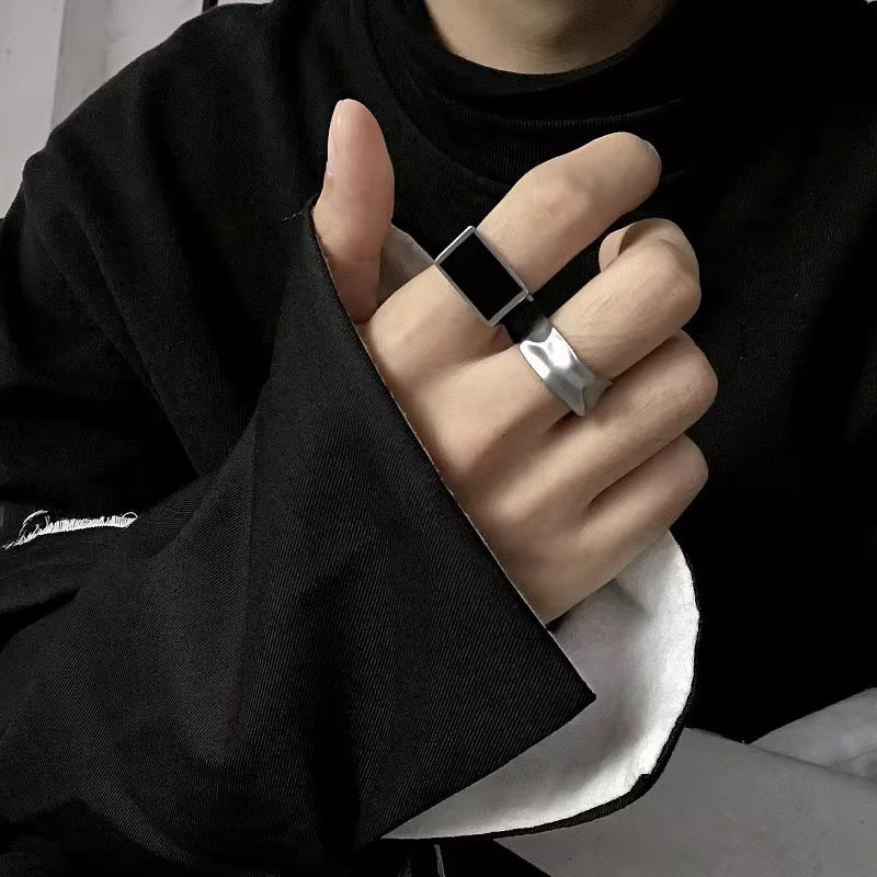 Person wearing two rings on a blurred background