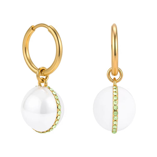 Gold hoop earrings with white spherical charms and green gemstones on a white background