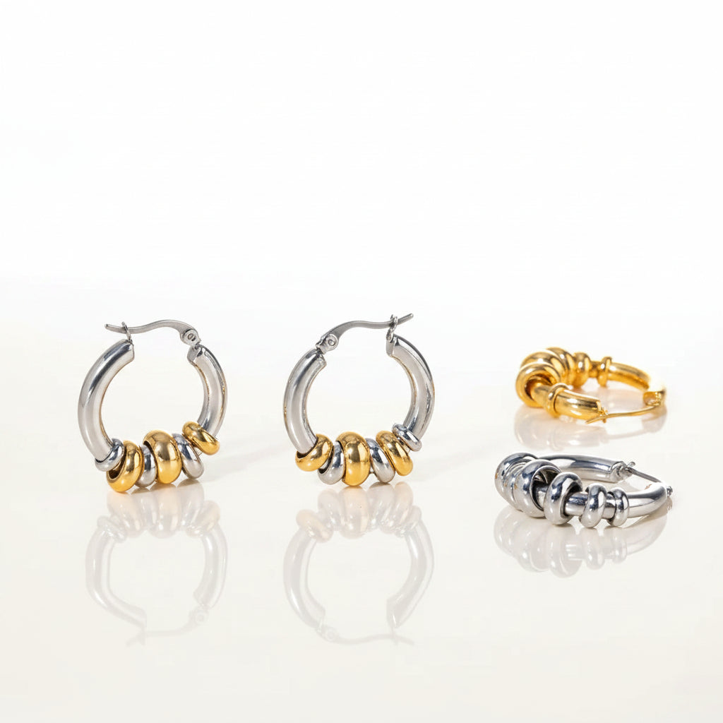 Set of silver and gold hoop earrings on a light background