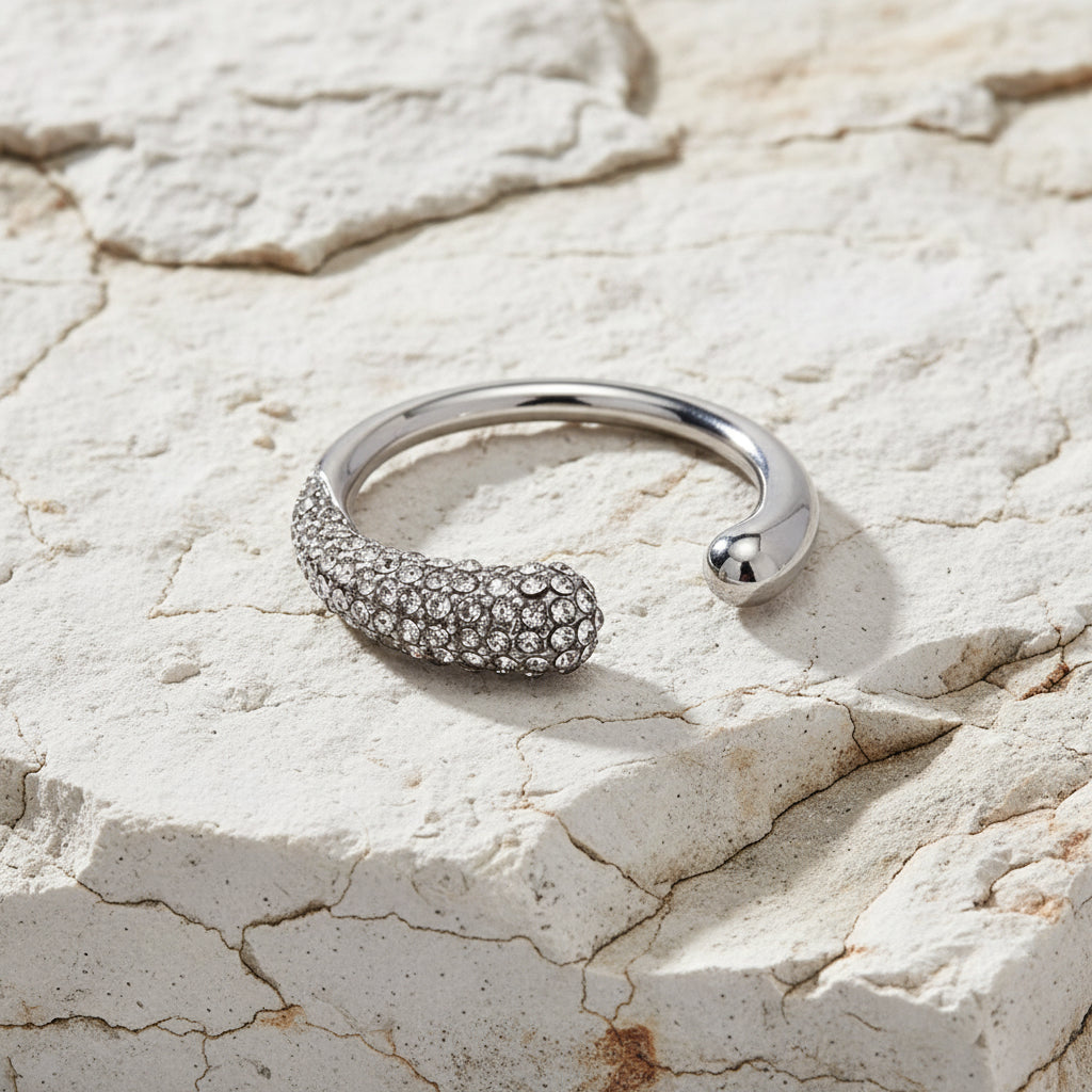 Silver ring with embedded stones on a white background