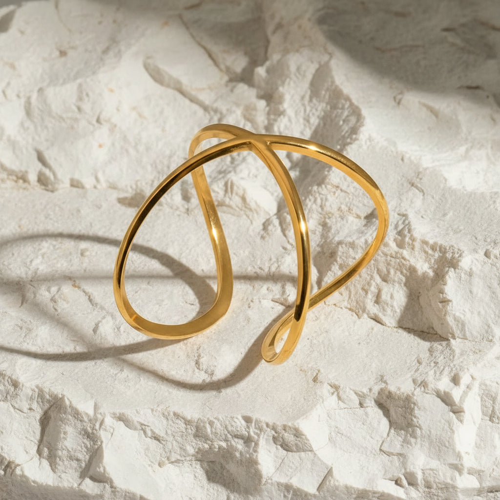 Gold hoop earrings on a textured white surface