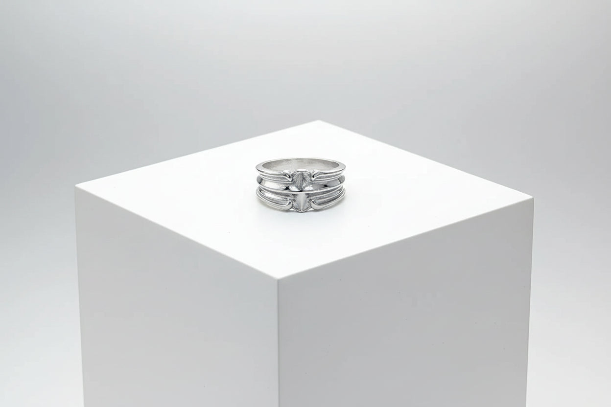Silver ring on a wooden surface with a dark background