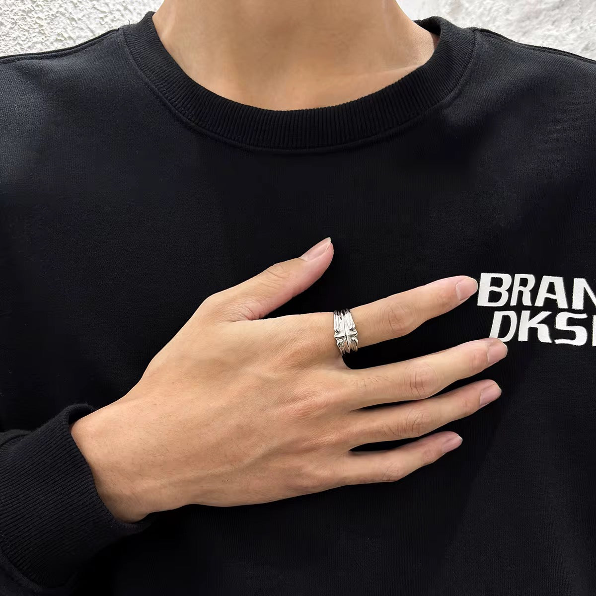 Person wearing a stainless steel silver colour unisex ring